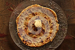 Delicious and nutritious Alu Paratha with pasteurized butter photo