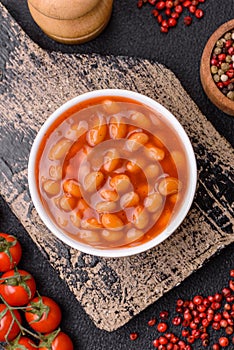 Delicious nutritious canned beans in tomato, with salt and spices