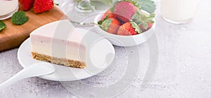 Delicious and nutritious handmade strawberry no bake frozen gradient colour fromage frais cheesecake slice with raw sarcocarp