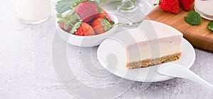 Delicious and nutritious handmade strawberry no bake frozen gradient colour fromage frais cheesecake slice with raw sarcocarp