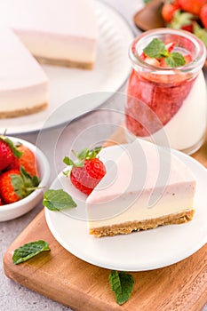 Delicious and nutritious handmade strawberry no bake frozen gradient colour fromage frais cheesecake slice with raw sarcocarp