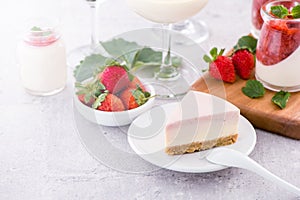 Delicious and nutritious handmade strawberry no bake frozen gradient colour fromage frais cheesecake slice with raw sarcocarp