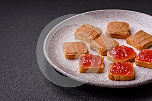 Delicious nutritious sandwiches with peanut butter, strawberry jam