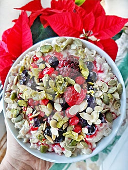 Delicious oatmeal breakfast with  berries  nuts seeds