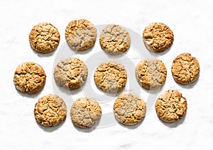 Delicious oatmeal gluten free cookies with walnuts on a light background, top view