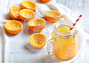 Delicious orange juice squeezed in the foreground in glass jar photo