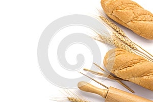 Delicious organic bread with ears of wheat isolated on white background - top view