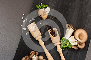 Delicious organic oyster mushrooms with spices and fresh parsley on wooden cutting board