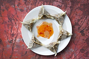 Delicious oriental Dim Sum dumplings on white plate on art baackground