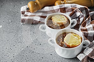 delicious original French onion soup on a light stone background