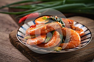 Delicious pan-fried shrimp on dark wooden table background