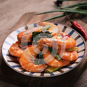 Delicious pan-fried shrimp on dark wooden table background
