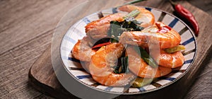 Delicious pan-fried shrimp on dark wooden table background