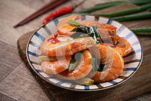 Delicious pan-fried shrimp on dark wooden table background