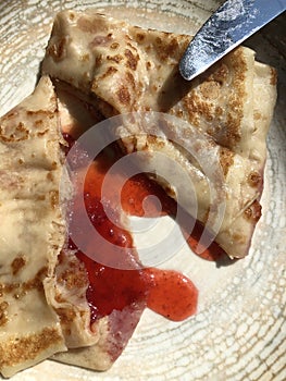 Delicious pancake with strawberry jam