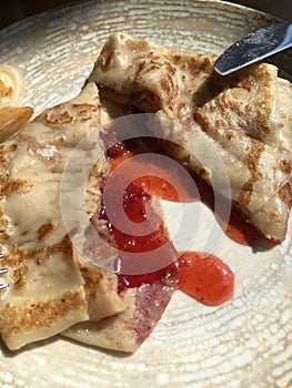 Delicious pancake with strawberry jam