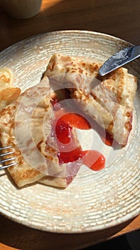 Delicious pancake with strawberry jam