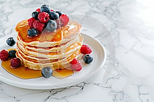 Delicious pancakes with berries, honey or maple syrup. Homemade pancakes and sweet syrup on white plate isolated.