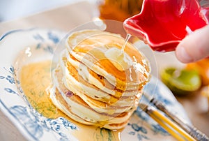 Delicious pancakes with butter and maple syrup