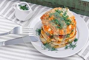 Delicious pancakes from courgettes and fresh vegetables with sour cream and dill