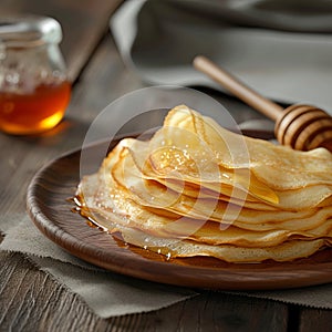 Delicious pancakes with honey or maple syrup. Homemade pancakes and sweet syrup on white plate isolated.