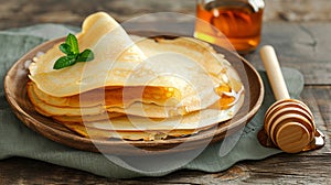 Delicious pancakes with honey or maple syrup. Homemade pancakes and sweet syrup on white plate isolated.