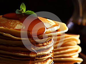 Delicious pancakes on plate with maple syrup