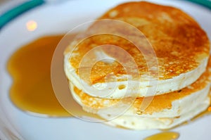 Delicious pancakes with sweet syrup photo