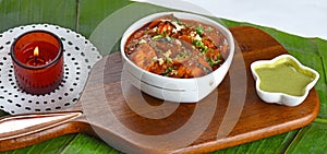 Delicious Paneer Lababdar or Curry North Indian Dish served in a white bowl with green mint chutney