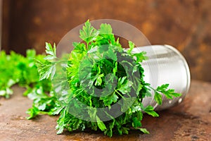 Delicious Parsley sprigs in a brown wicker basket and wooden board. Garden parsley herbs. Organic effective source of anti-oxidant
