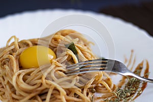 Delicious pasta with egg yolk, on wooden table