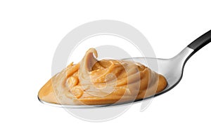 Delicious peanut butter in spoon isolated on white