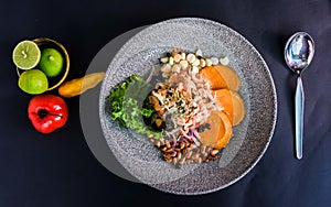Delicious Peruvian ceviche dish in a beautiful plate on black surface