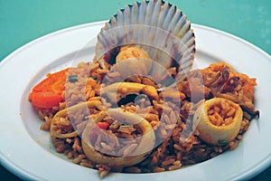 Delicious Peruvian dish of seafood rice. Cangrejo, guisantes, perejil, Prawns, scallops, mussels, clams, squid, red onion, and photo