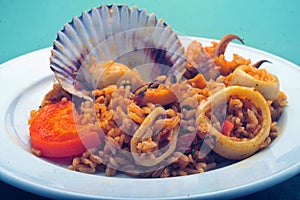 Delicious Peruvian dish of seafood rice. Cangrejo, guisantes, perejil, Prawns, scallops, mussels, clams, squid, red onion, and photo