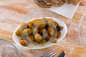 Delicious pickled green olives with cucumber, spanish dish - Olivas verdes y pepinos