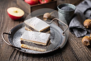 Delicious pie made from leavened dough with poppy seed and apple filling, sprinkled with powdered sugar