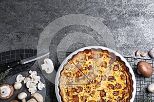 Delicious pie with mushrooms and cheese served on dark grey table, flat lay. Space for text