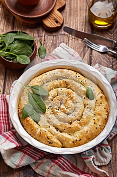 Delicious pie with spinach and feta cheese, made from filo pastry, decorated with sesame seeds