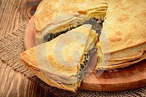 Delicious pie with spinach and feta cheese - spanakopita, traditional greek cuisine.