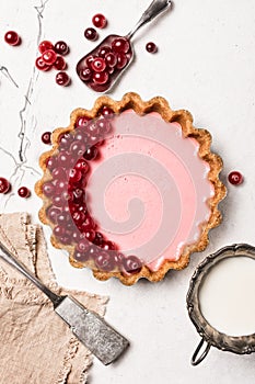 Delicious pink open tart with fresh cranberry and vintage silverware