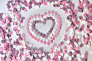 Delicious pink ValentineÂ´s Day sugar hearts and ornaments in pink, purple and white show I love you to your beloved girlfriend