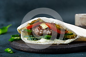 Delicious pita bread with meat, tomatoes and pepper. Pita with kebab. Shawerma with meat