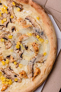 Delicious pizza with corn, cheese, tomatoes and mushrooms, salt, spices and herbs