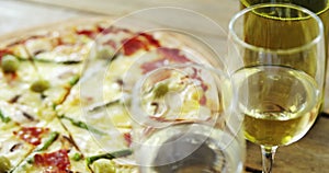 Delicious pizza with a glasses of wine and wine bottle