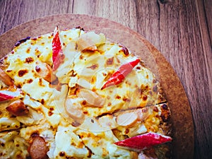 Delicious pizza served on wooden table