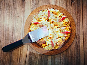 Delicious pizza served on wooden table