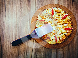 Delicious pizza served on wooden table