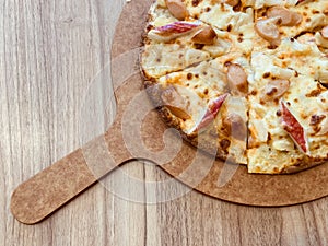 Delicious pizza served on wooden table