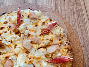 Delicious pizza served on wooden table